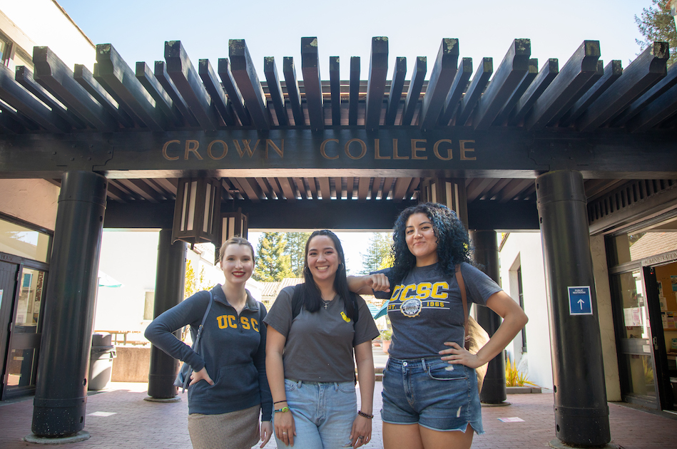Three students smiling in front of the Crown Breezeway